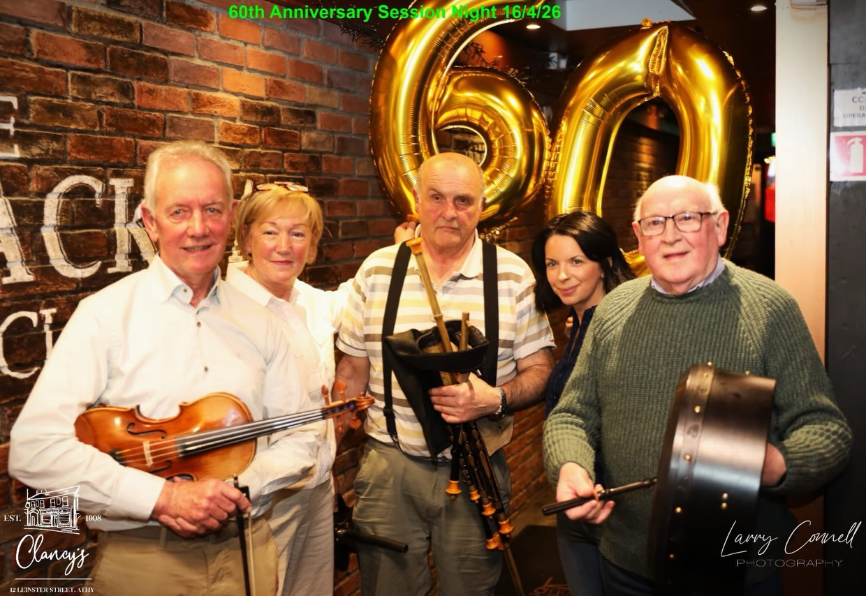 Musicians beneath gold '60' balloons celebrating six decades