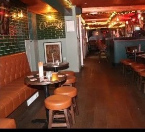 Back bar with leather booths and warm lighting