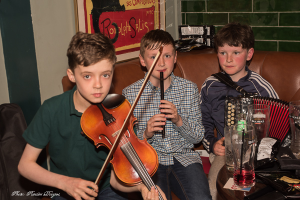 Three young musicians with fiddle and tin whistle